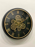 Wall clock with gold gears and Roman numerals on a black background