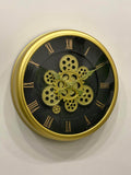 Wall clock with gold gears and Roman numerals on a white background