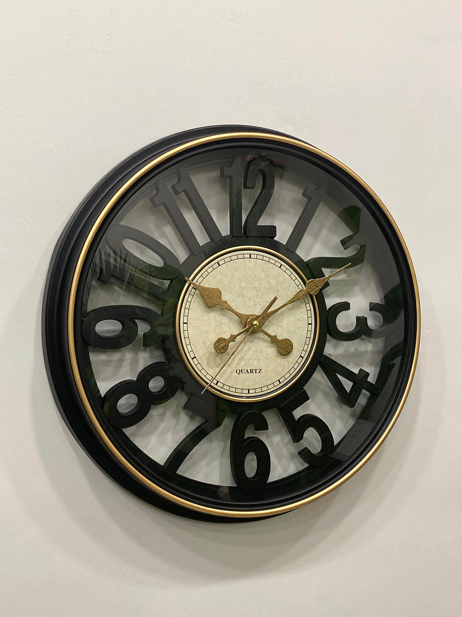 Modern wall clock for living room décor
Round wall clock with black frame and gold accents on a white wall