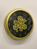 Modern wall clock for living room décor
Wall clock with gold gear design on a black face against a white background