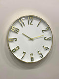 Round wall clock with gold frame and numbers on a light gray background
Modern wall clock for living room décor