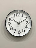 Modern wall clock for living room décor
Round wall clock with black frame and white face on a light gray wall.