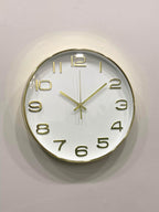 Modern wall clock for living room décor
Gold-framed wall clock on a light gray background