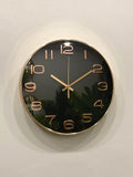 Modern wall clock for living room décor
Wall clock with black face and rose gold hands on a white wall