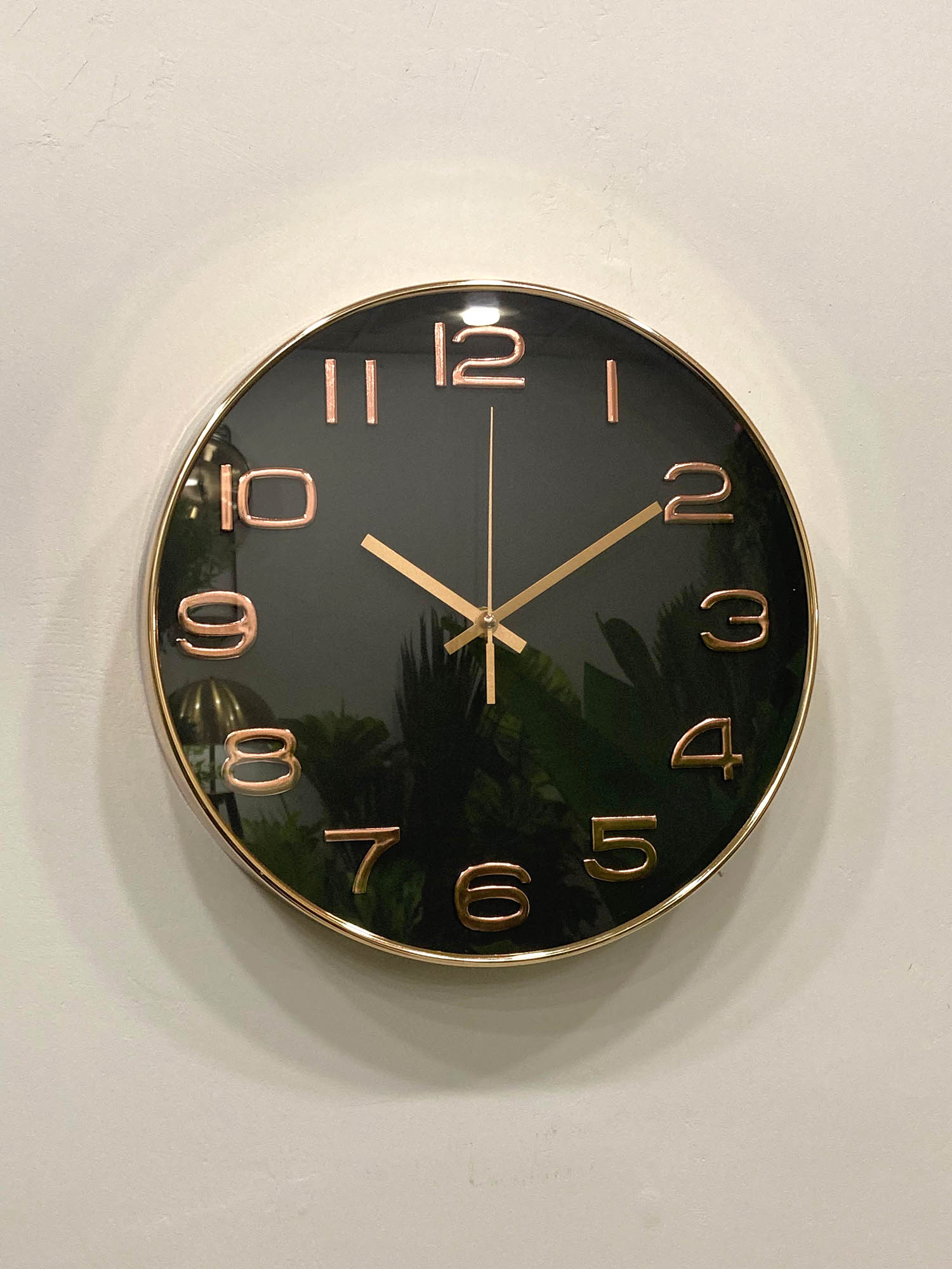 Modern wall clock for living room décor
Wall clock with black face and rose gold hands on a white wall