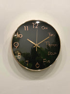 Modern wall clock for living room décor
Wall clock with black face and gold casing on a white wall