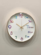Modern wall clock for living room décor
Colorful clock with numbers and letters on a white wall suitable for kids room clock 