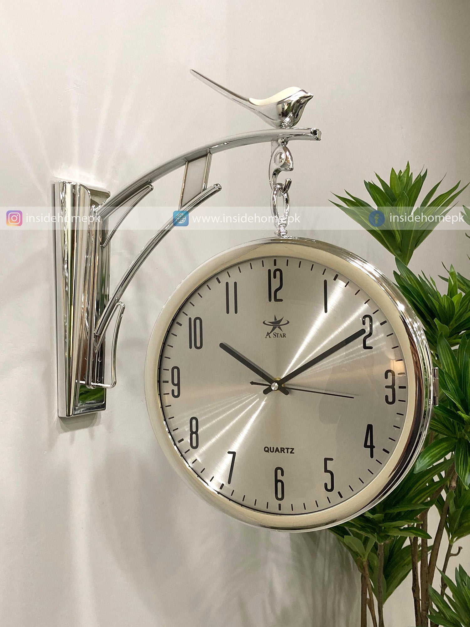 Decorative Modern wall clock for living room décor with bird design on a white wall.