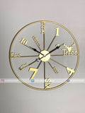 Gold Modern wall clock for living room décor with decorative design on a gray background