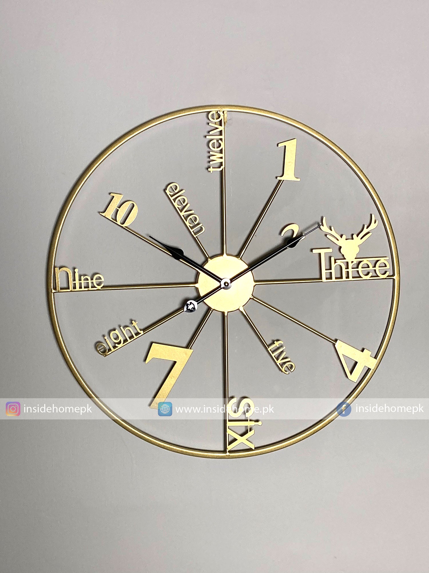 Gold Modern wall clock for living room décor with decorative design on a gray background