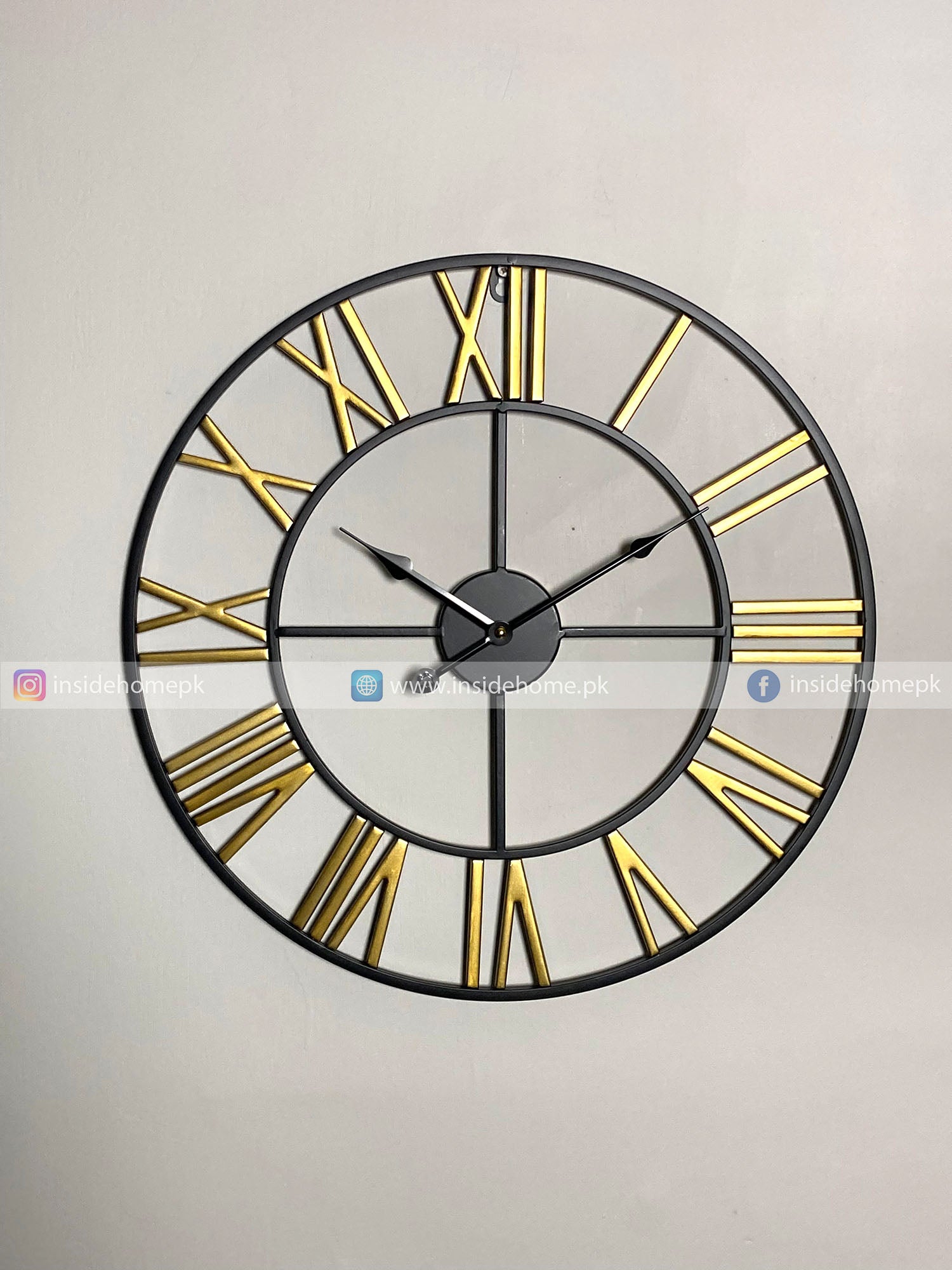 Large Modern wall clock for living room décor with gold Roman numerals on a light gray background