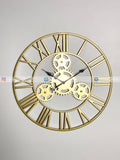 Gold mechanical Modern wall clock for living room décor with Roman numerals on a light gray background