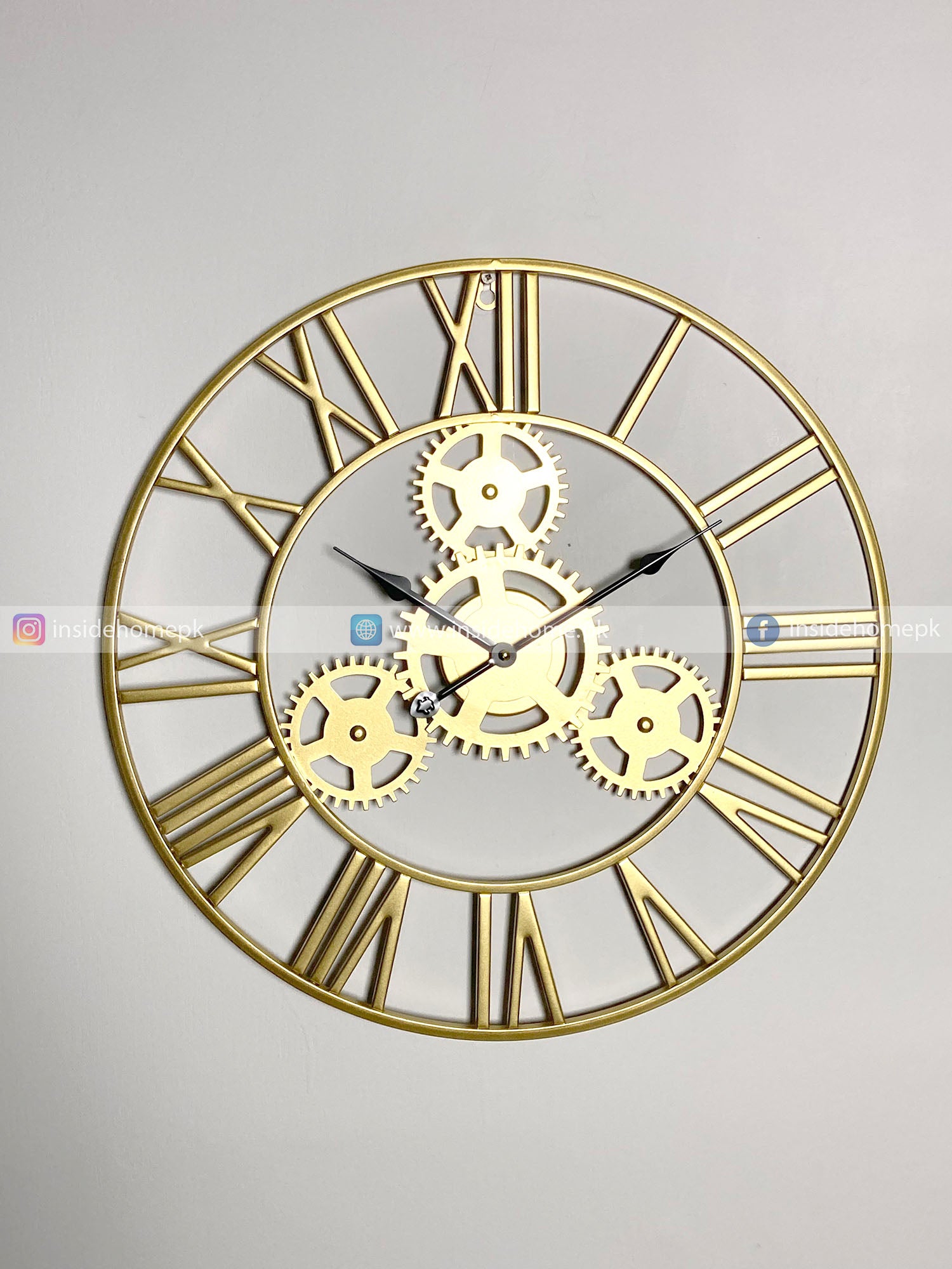 Gold mechanical Modern wall clock for living room décor with Roman numerals on a light gray background