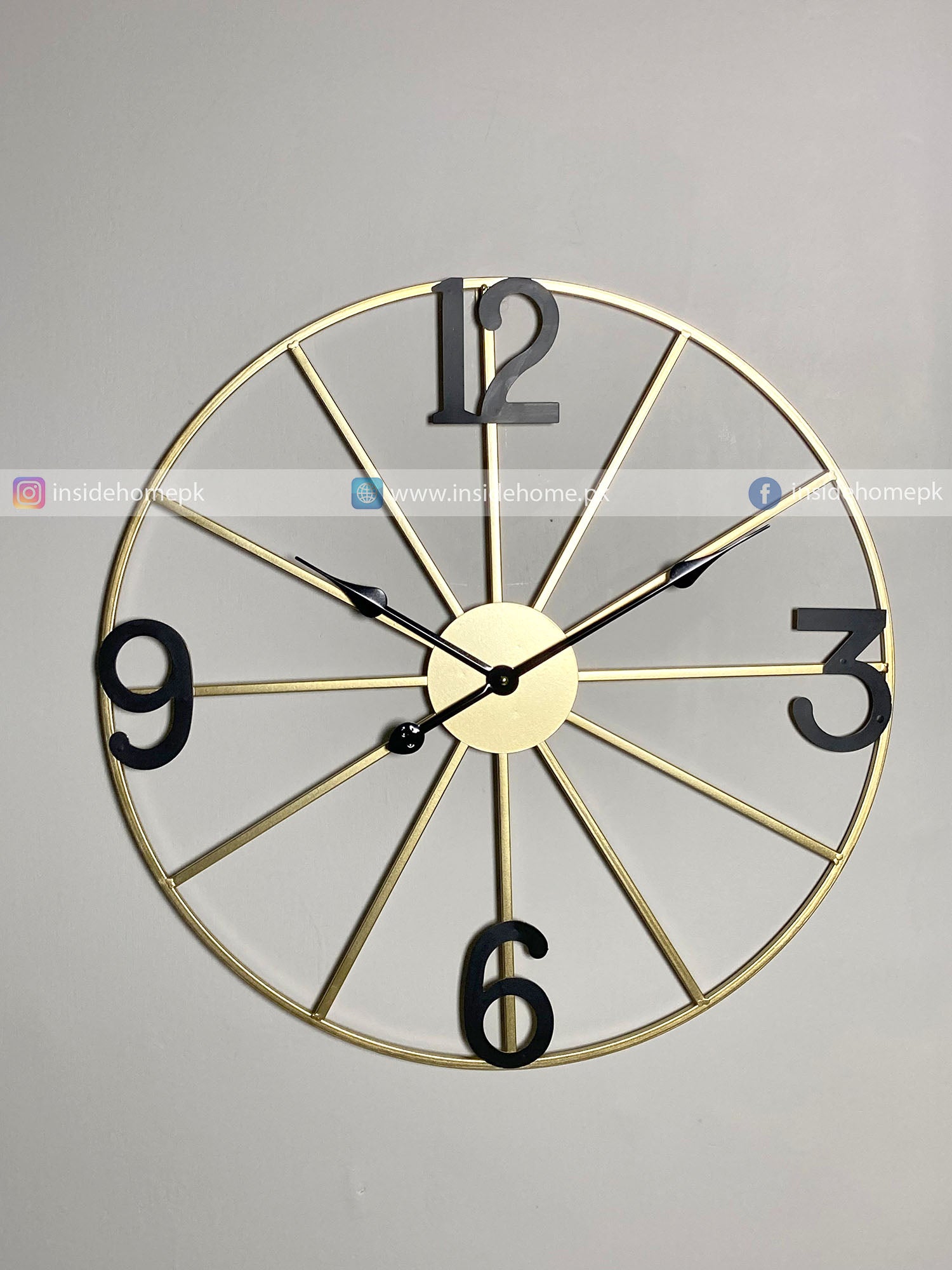 Decorative Modern wall clock for living room décor with gold frame and black numbers on a gray background