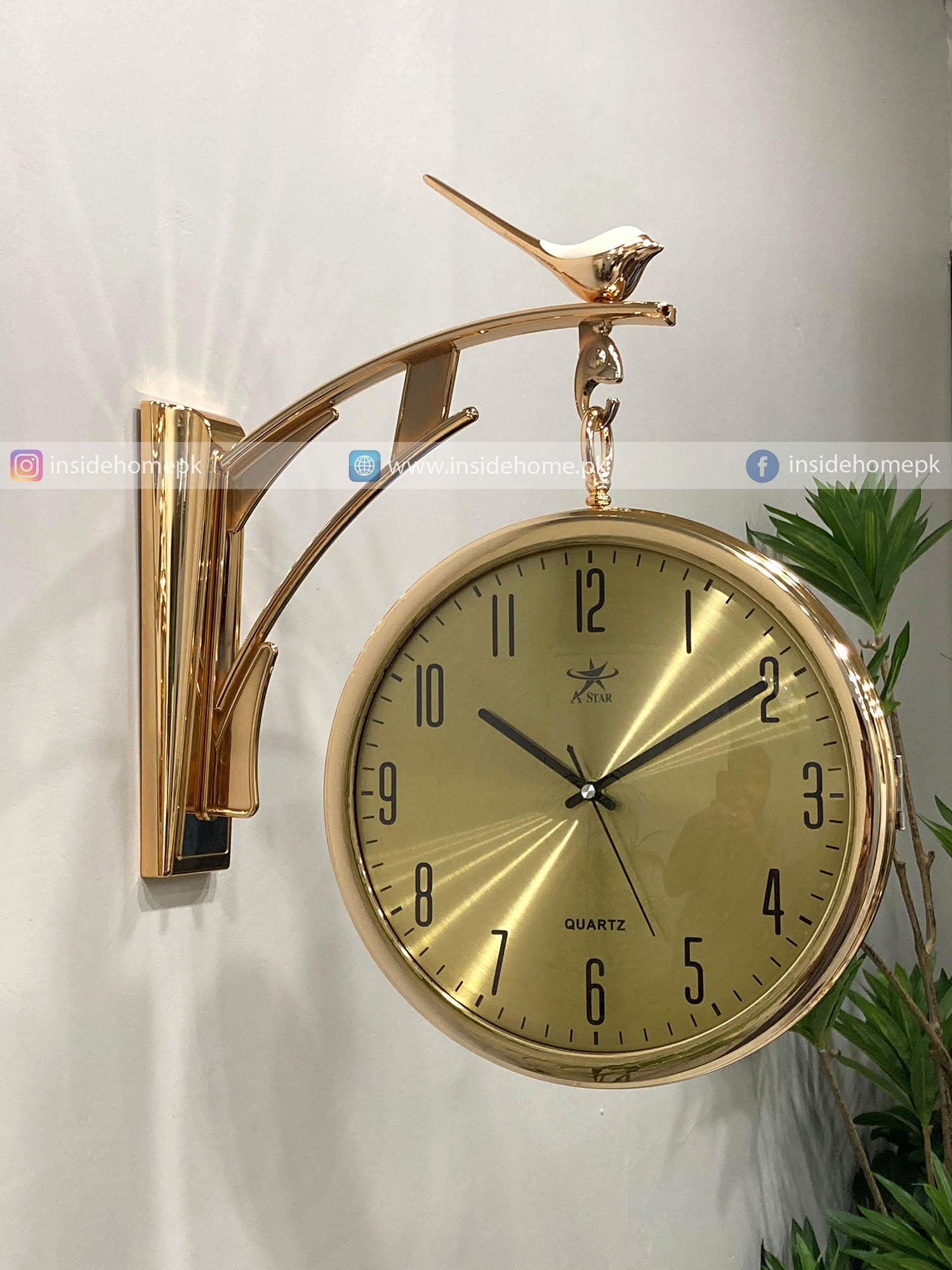 Gold Modern wall clock for living room décor with bird design on a white wall