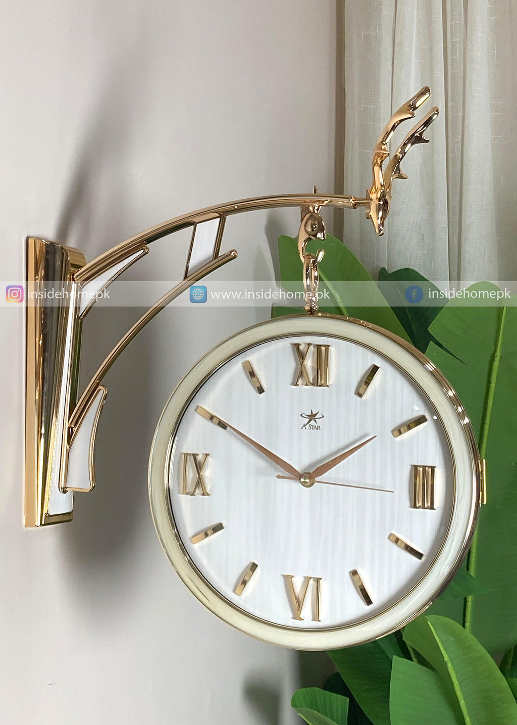 Modern wall clock for living room décor    
Gold wall clock with white face and Roman numerals on a light background